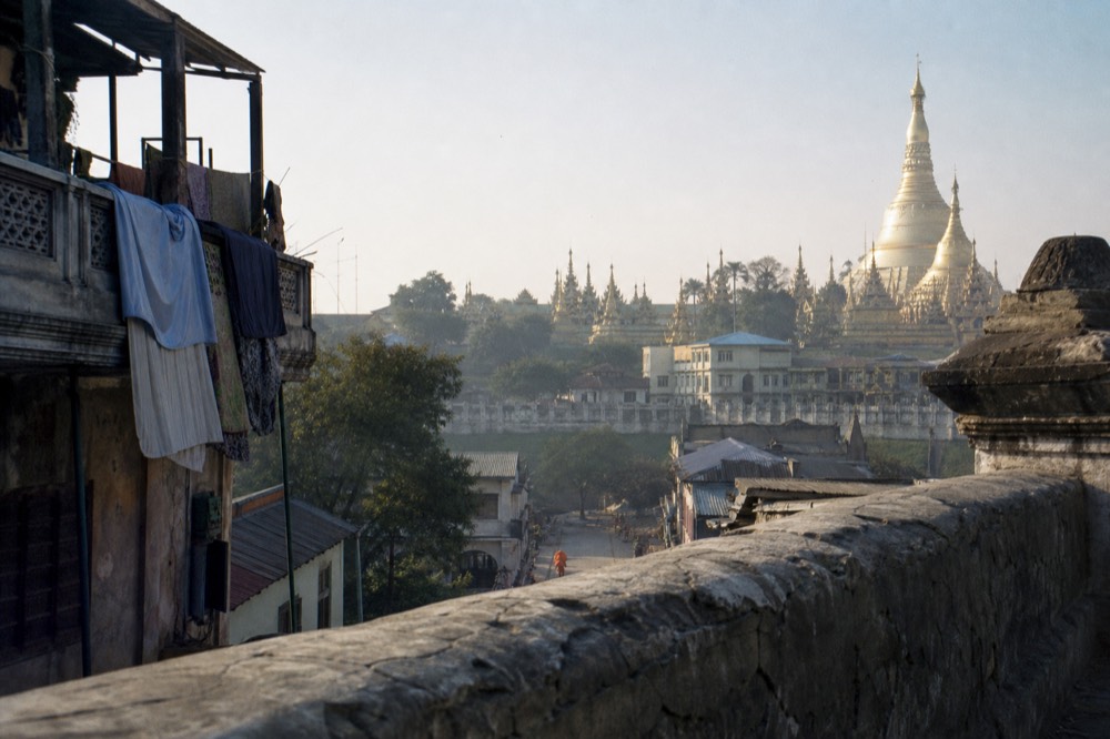 Golden temple spires against a morning sky in Bangkok's Old City, no text, no logos, no people.