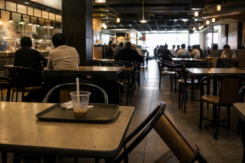 A Bangkok food court with steaming dishes on counters, no text, no logos, no people.