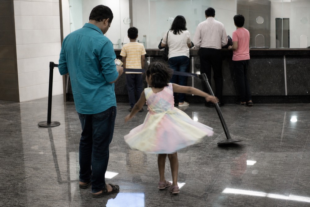 Ticket counter queue at an aquarium entrance in a shopping mall basement, no text, no logos, no people